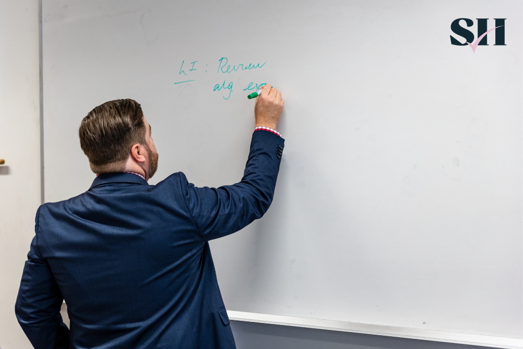 Teacher Writing On A Board